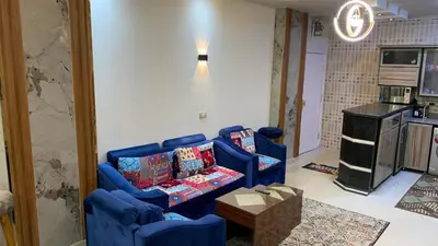 a living room with two blue couches and a table at Apartment in Center of Hurghada in Hurghada