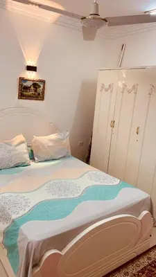 a bedroom with a large bed with white sheets at Apartment in Center of Hurghada in Hurghada