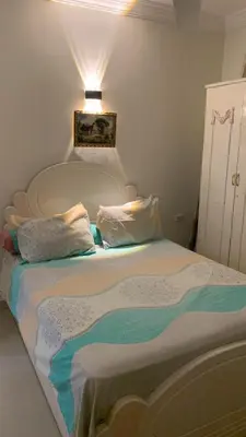 a bed with two pillows on it in a room at Apartment in Center of Hurghada in Hurghada