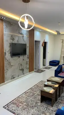 a lobby with a tv on a marble wall at Apartment in Center of Hurghada in Hurghada