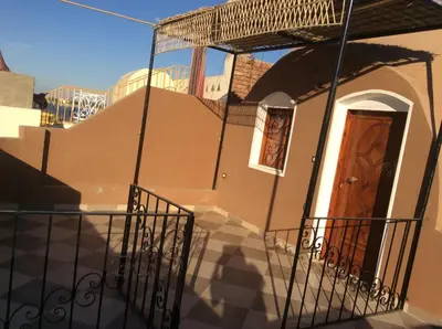 a house with a wooden door on the side at The Brown House in Luxor