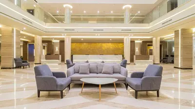 a lobby with a couch and chairs and a table at Amarina Abu Soma Resort & Aquapark in Hurghada