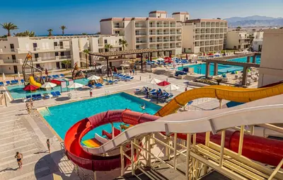 a large swimming pool with a water slide at a resort at Amarina Abu Soma Resort & Aquapark in Hurghada