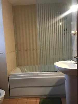a bathroom with a shower and a tub and a sink at Sea View One Bedroom in Hurghada - H105 in Hurghada