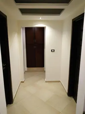 a hallway with a door and a tile floor at Elite Suites Hurghada in Hurghada