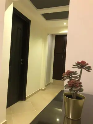 a hallway with a vase with a plant in it at Elite Suites Hurghada in Hurghada
