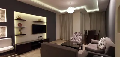 a living room with a couch and a tv at Elite Suites Hurghada in Hurghada