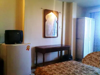 a room with a small television and a small table at Orchida St. George Hotel in Aswan