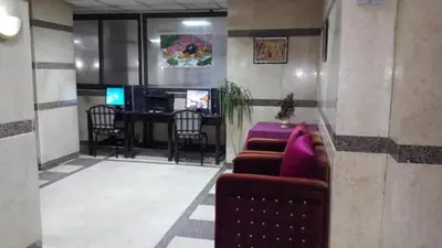 a lobby with a couch and a desk with a computer at Orchida St. George Hotel in Aswan