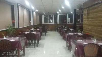 a room filled with tables and chairs with purple tables at Orchida St. George Hotel in Aswan