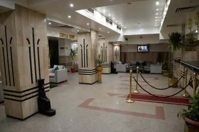 a lobby with columns and couches in a building at Marhaba Palace Hotel in Aswan