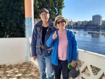 a man and a woman standing next to a river at NiLe ViEW RANA NUbian Guest HOUES in Aswan