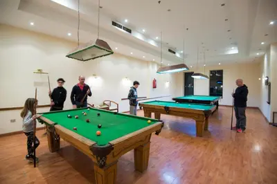 a group of people playing pool in a room at Imperial Shams Abu Soma in Hurghada