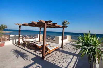 a gazebo with tables and chairs on the beach at Imperial Shams Abu Soma in Hurghada