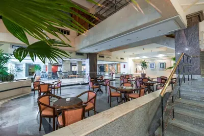 a restaurant with tables and chairs in a building at Shams Safaga Resort in Hurghada