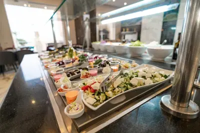 a buffet line with many plates of food at King Tut Aqua Park Beach Resort in Hurghada