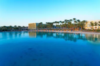 a large body of water with a beach and buildings at Regina Resort and Aqua Park Hurghada in Hurghada