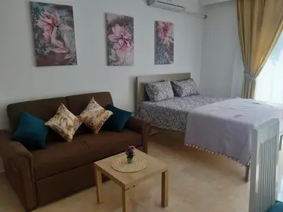 a living room with a couch and a bed at Exoticky apartman in Hurghada