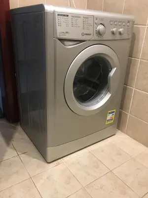 a silver washing machine sitting on a tile floor at Pool View one bedroom at Hurghada - B101 in Hurghada