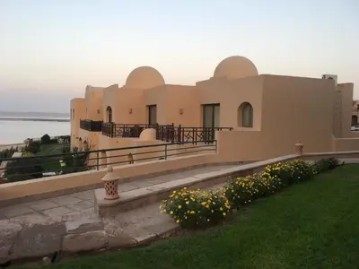 a large house with a lawn and flowers at Pool View one bedroom at Hurghada - B101 in Hurghada
