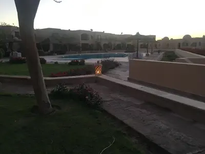 a garden with a lit candle next to a pool at Pool View one bedroom at Hurghada - B101 in Hurghada