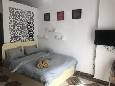 a bedroom with a bed with two shoes on it at apartman Eva in Hurghada