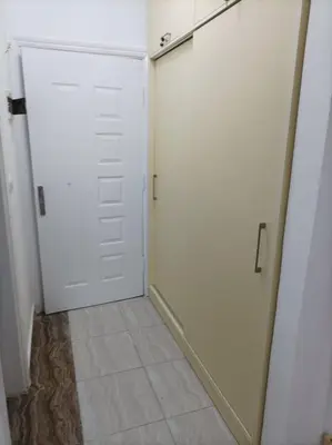 a room with two white doors and a tile floor at apartman Eva in Hurghada