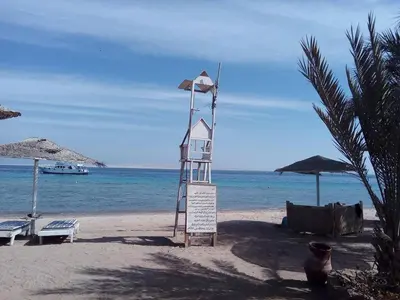 a life guard tower on a beach with the ocean at apartman Eva in Hurghada