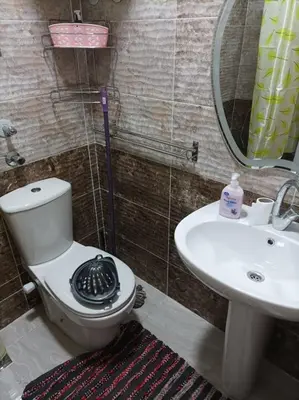 a bathroom with a toilet and a sink at apartman Eva in Hurghada