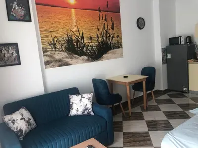 a living room with a couch and a table at apartman Eva in Hurghada
