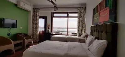 a bedroom with a large bed and a large window at Villa Misk in Aswan