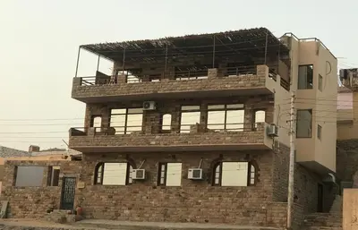 a brick building with a balcony on top of it at Villa Misk in Aswan