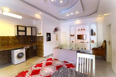 a living room with a washer and dryer at Mama Africa Apts & Studios in Luxor