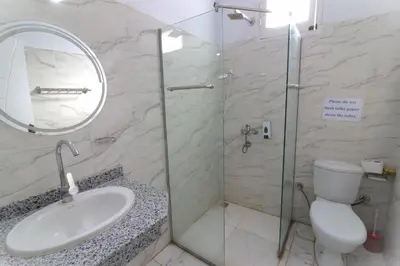 a bathroom with a shower and a sink and a toilet at Mama Africa Apts & Studios in Luxor