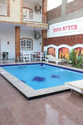 a large swimming pool in the middle of a building at Mama Africa Apts & Studios in Luxor