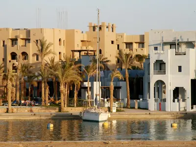 a boat in the water in front of buildings at Marina Lodge at Port Ghalib in Port Ghalib