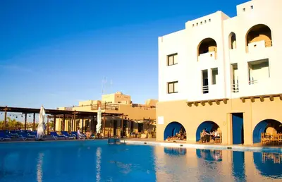 a swimming pool in front of a building at Marina Lodge at Port Ghalib in Port Ghalib