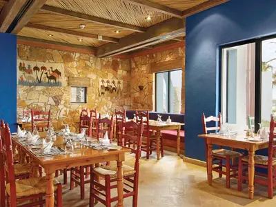 a dining room with wooden tables and chairs at Marina Lodge at Port Ghalib in Port Ghalib
