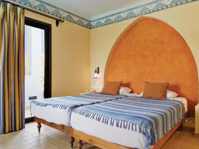 a bedroom with a large bed with a large window at Marina Lodge at Port Ghalib in Port Ghalib