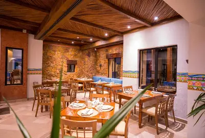 a dining room with wooden tables and chairs at Marina Lodge at Port Ghalib in Port Ghalib
