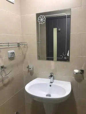 a bathroom with a white sink and a mirror at Hurghada Furnished Appratment - Al Dau Hights Al Mamsha in Hurghada