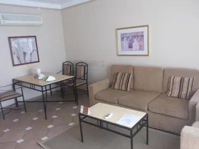 a living room with a couch and two tables at JAZ Neo Ivory in Hurghada