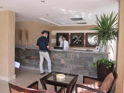 two men standing at a counter in a restaurant at JAZ Neo Ivory in Hurghada