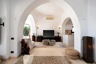 a living room with white walls and an archway at VESTA - El Gouna Residence in Hurghada