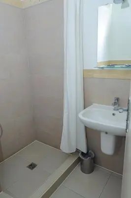 a bathroom with a sink and a shower curtain at Cleopatra Hotel in Aswan