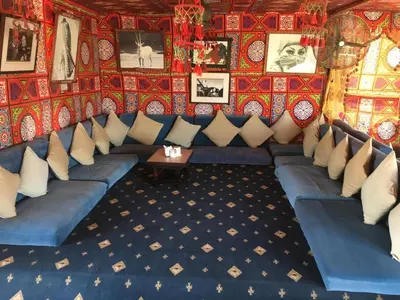 a room with a blue couch and a red wall at Apartment in Stella di Mare Hurghada in Hurghada