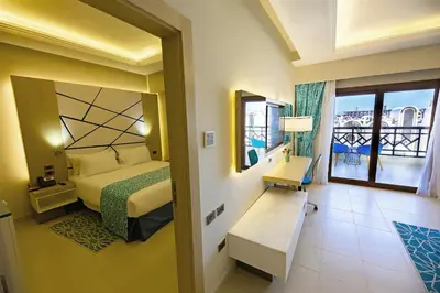 a hotel room with a bed and a balcony at Gravity Hotel & Aqua Park Sahl Hasheesh Families and Couples Only in Hurghada