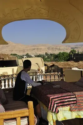 a man is making a table with a view at Al Hambra Hotel in Luxor
