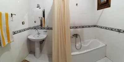 a bathroom with a sink and a bath tub and a toilet at Al Hambra Hotel in Luxor