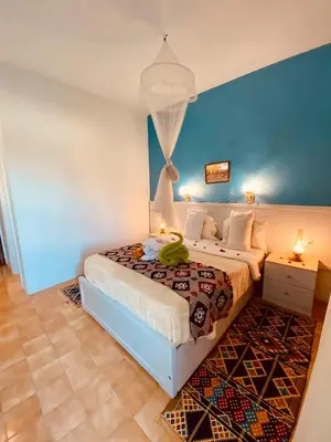 a bedroom with a bed with a banana on it at El Gezira Hotel in Luxor